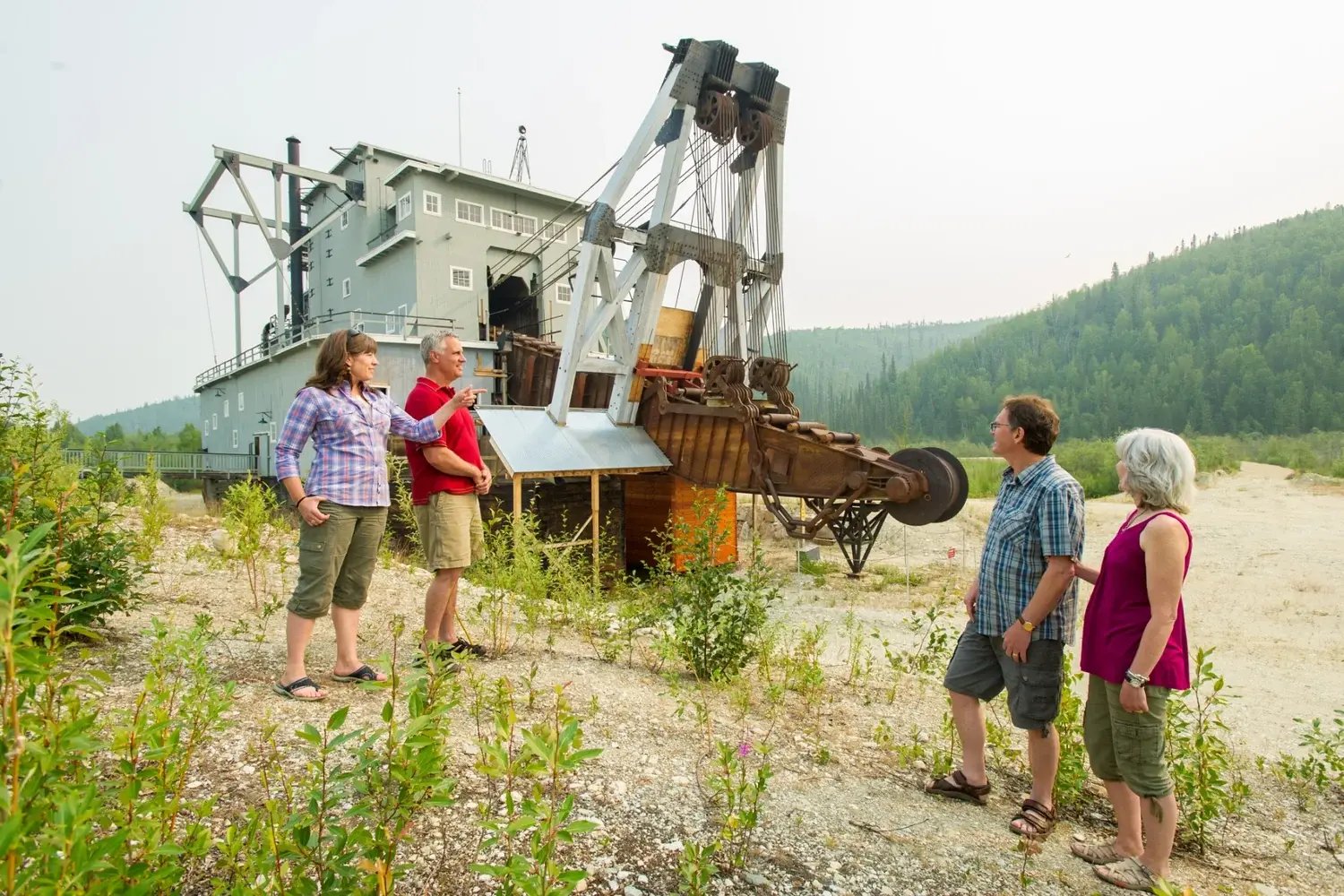 Guests viewing Dredge No. 4 National Historic Site near Dawson City, a large gold dredge from the Klondike era.