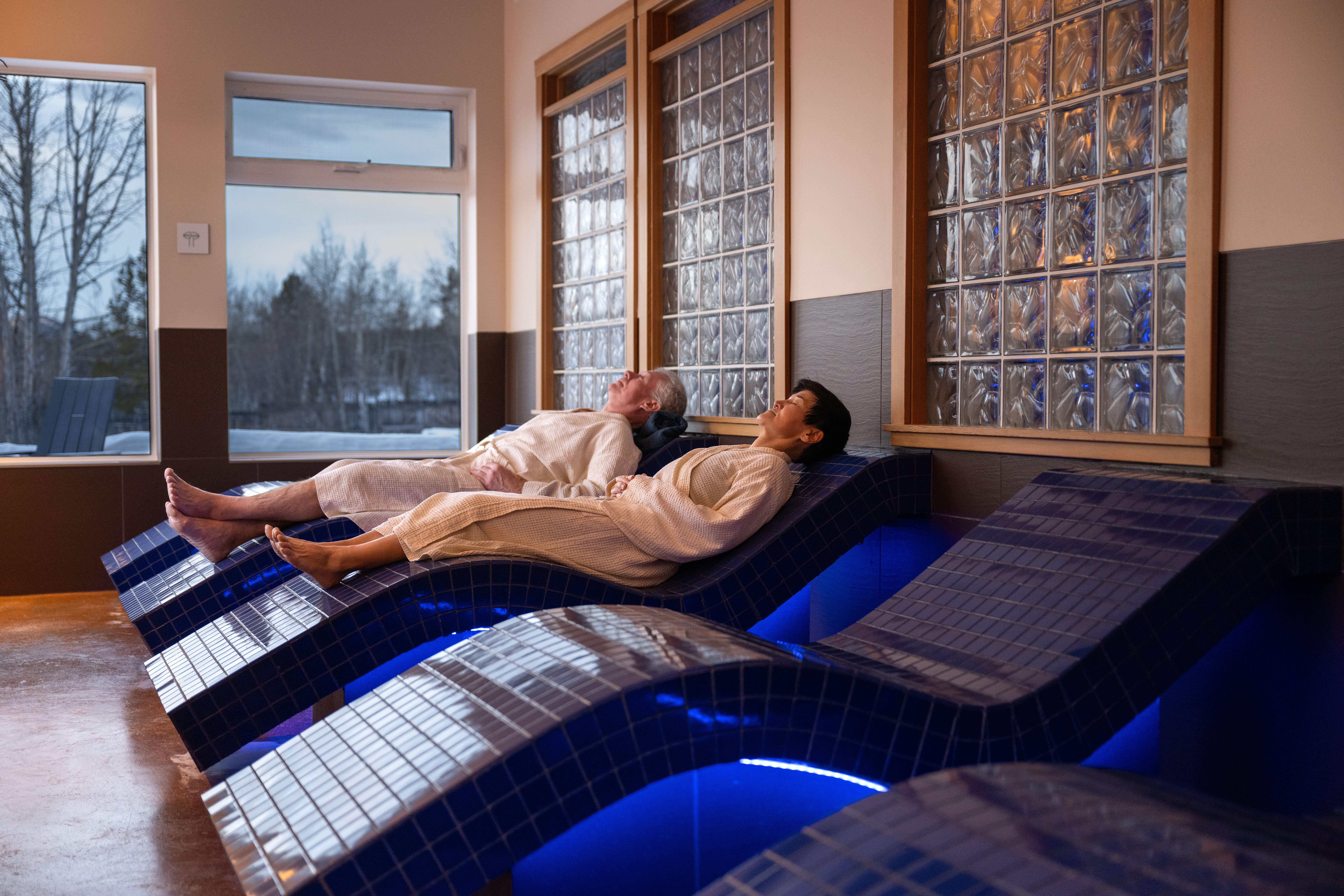 Heated loungers at Eclipse Nordic Hot Springs, offering a quiet place to rest between Nordic spa stages.