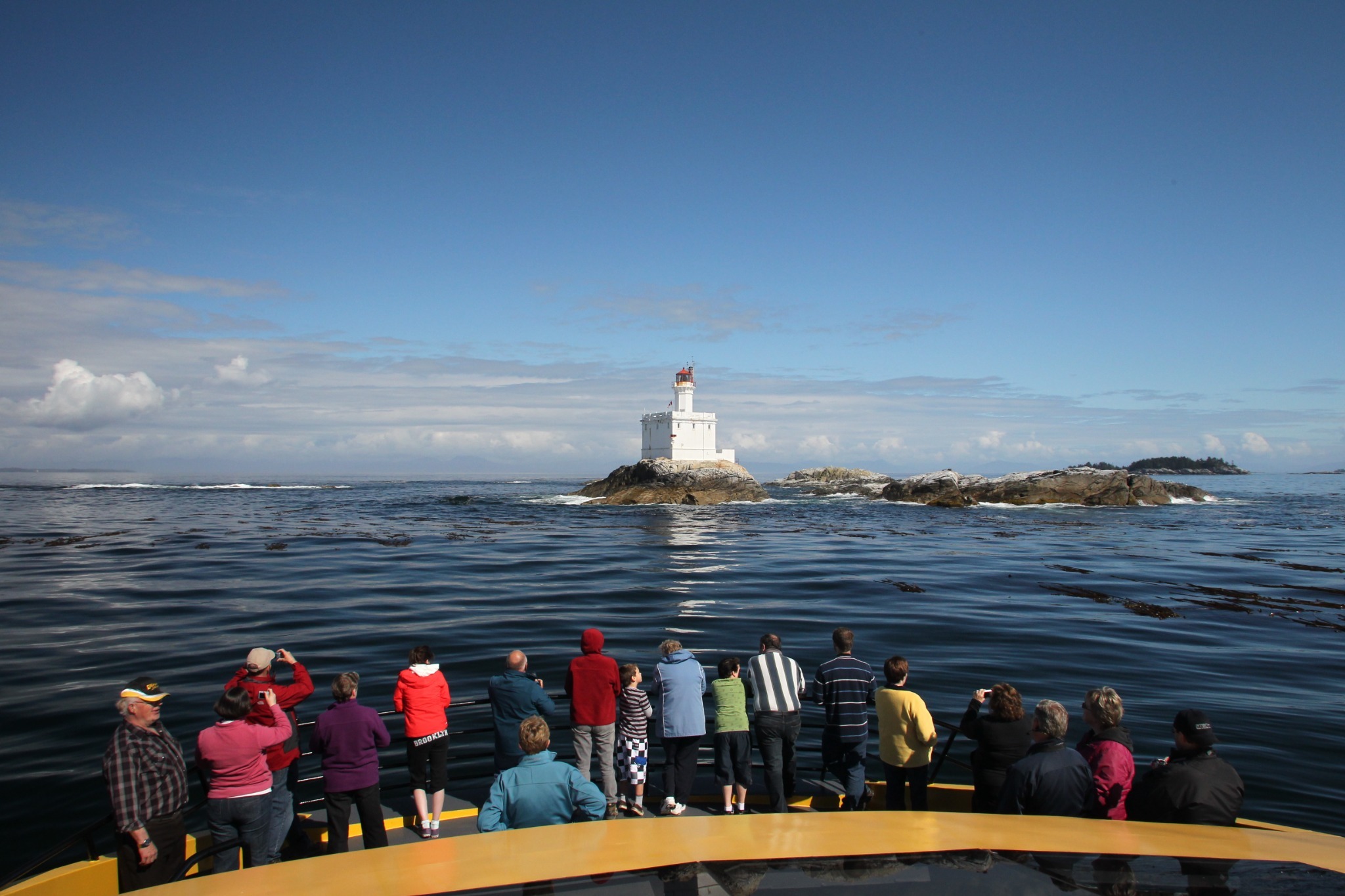 Guests aboard the M/V Inside Passage viewing Triple Island Lighthouse in Chatham Sound.