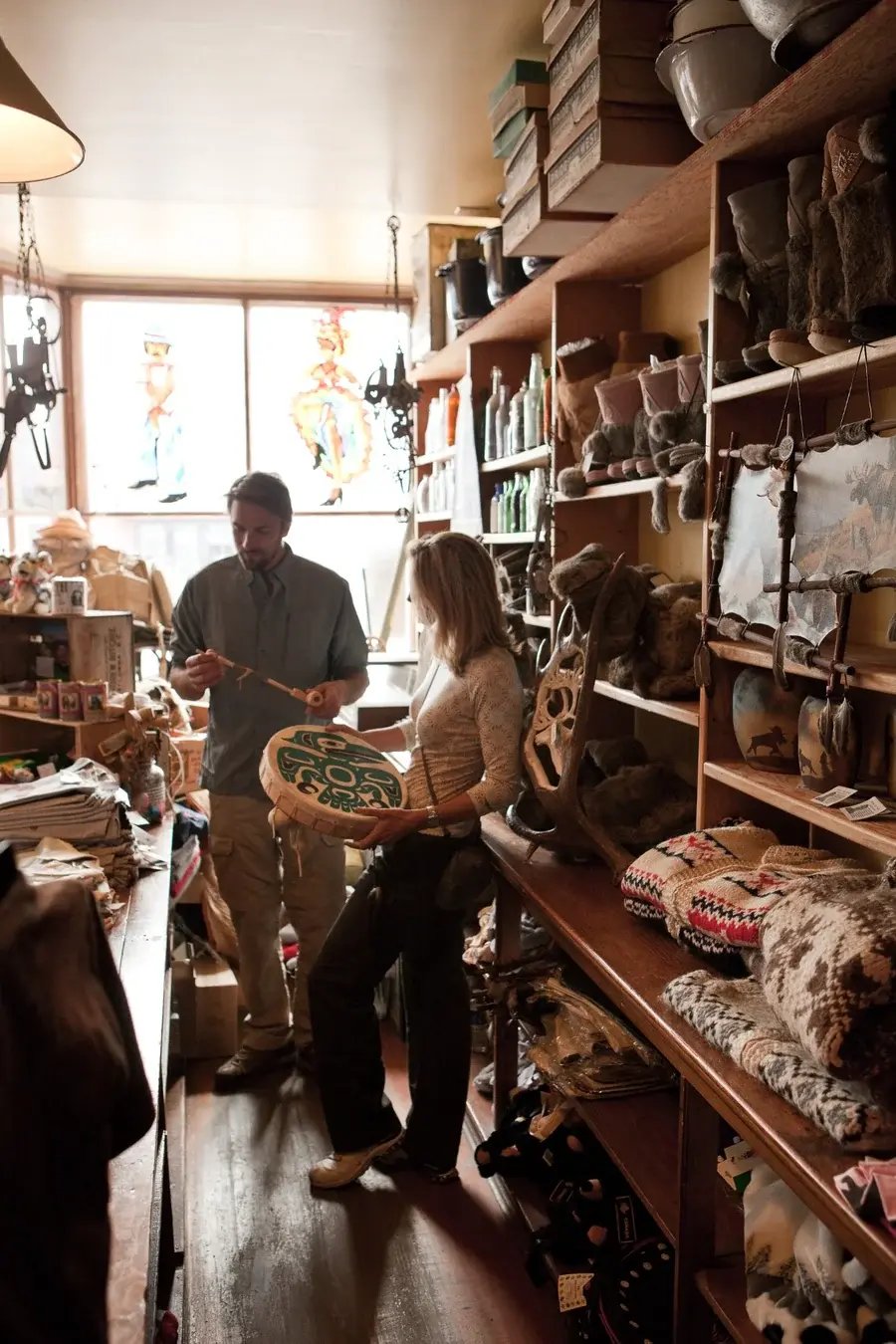 Guests browsing souvenirs, locally made items, and northern goods inside Matthew Watson General Store in historic Carcross.